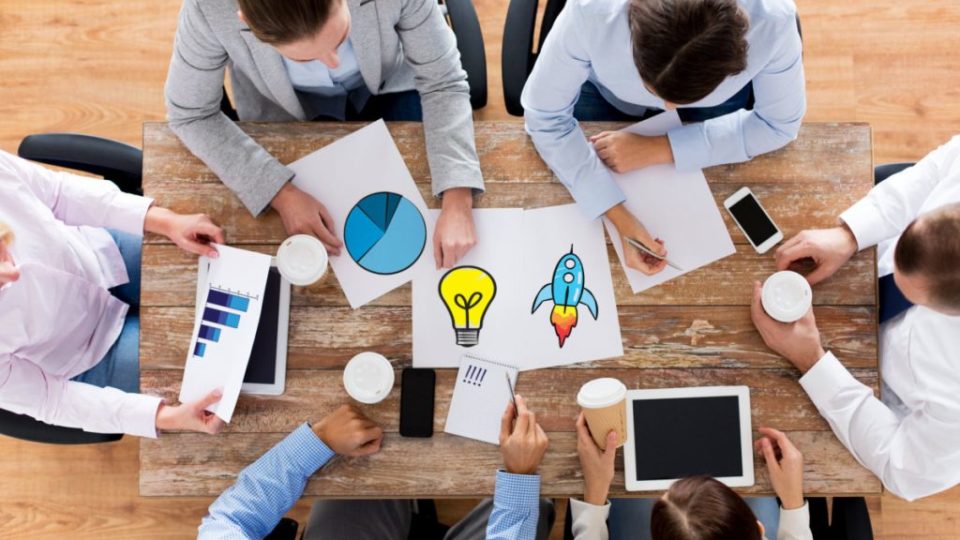 close up of business team with coffee and papers